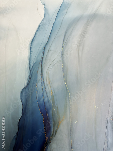 Abstract blue background with gold and bronze — fluid art texture made with alcohol ink and liquid potal. Blue with gold natural art backdrop resembles watercolor or aquarelle.