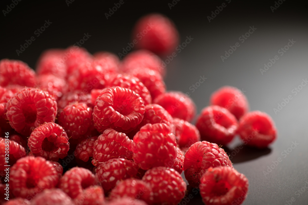 Raspberry fresh berries closeup, ripe fresh organic Raspberries over black background, macro shot. Harvest concept, border design Raspberry fresh berries closeup, ripe fresh organic Raspberries over black background, macro shot. Harvest concept, border design