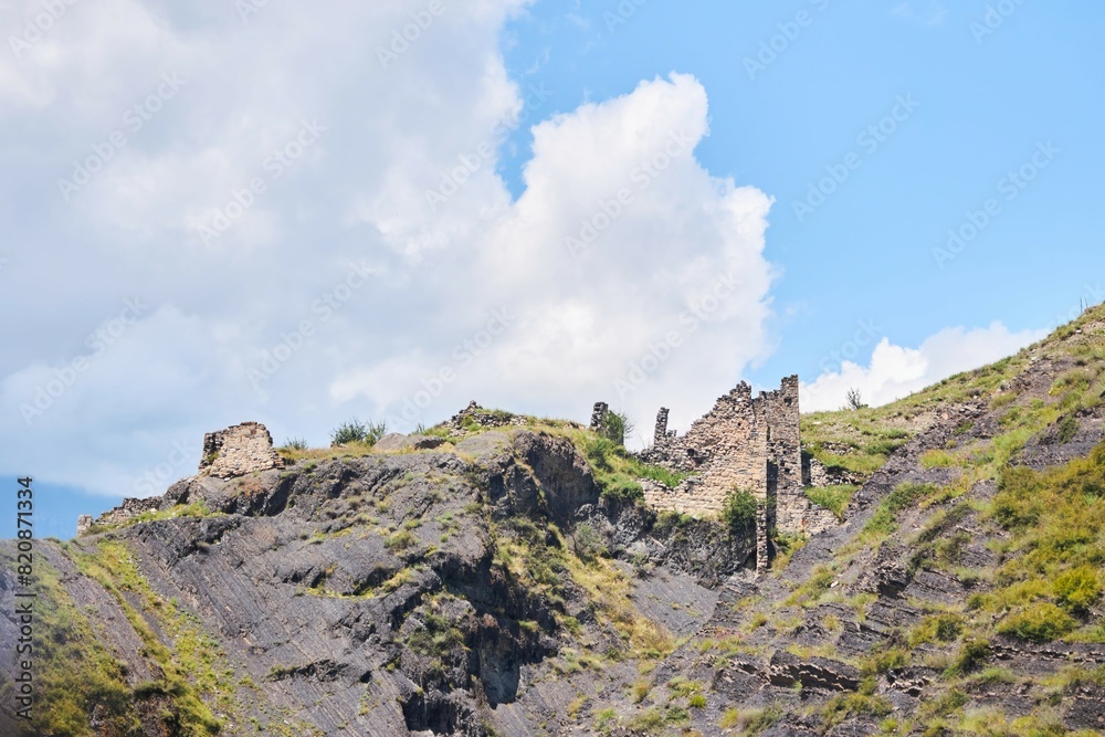 The ruins of an ancient tower on the top of the mountain. The Caucasus Mountains