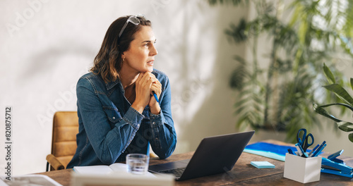 Pensive businesswoman in a stylish denim jacket