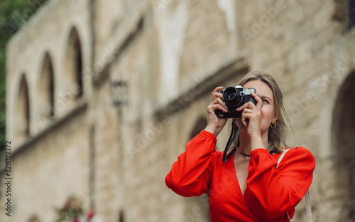 Woman takes photographs of the ancient city. © M-Production