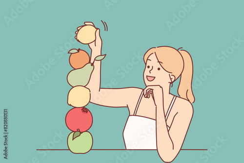 Woman builds fruit pyramid using organic food bought at farmers market to detox body