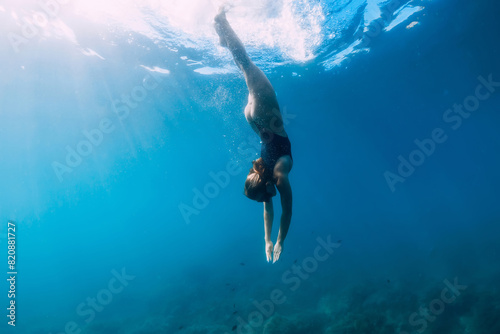 Woman swims in clear sea. Freediving and beautiful lady in ocean