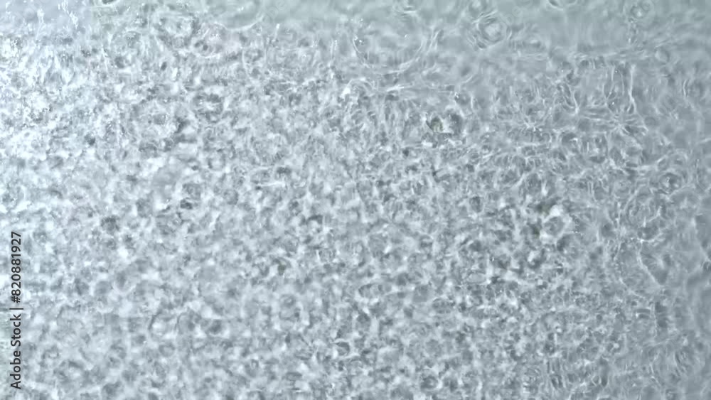 Rain on water surface is adorned with an array of water droplets, creating dynamic and refreshing visual effect.