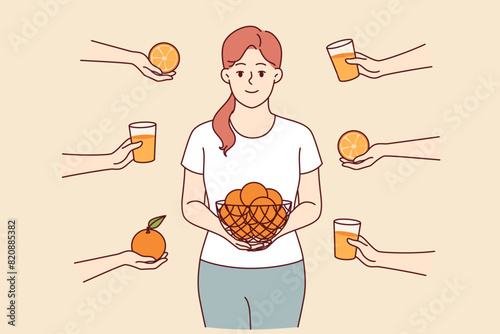 Woman eats oranges and drinks freshly squeezed citrus fruit juice to get health-improving vitamin C. Girl stands among hands with oranges and glasses with healthy drink that strengthens immune system.
