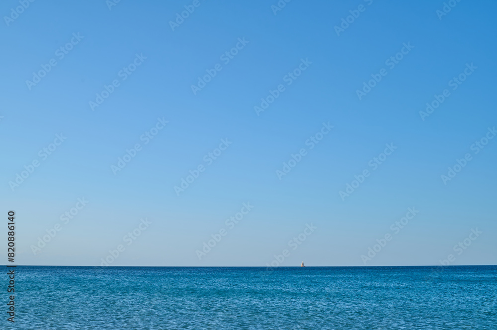 Obraz premium A sailboat on the beach of Les Bovetes, near Denia. Alicante. Valencian Community. Spain