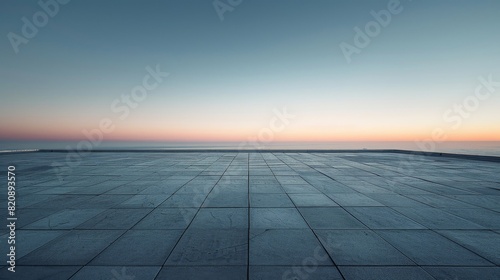 A vast, empty seaside square with the sky gradient of dawn stretching out to the horizon © Oskar
