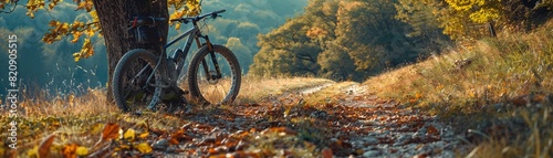 Wallpaper Mural A mountain bike propped against a tree with a scenic trail stretching into the distance, symbolizing endurance, adventure, and the joy of offroad biking Torontodigital.ca