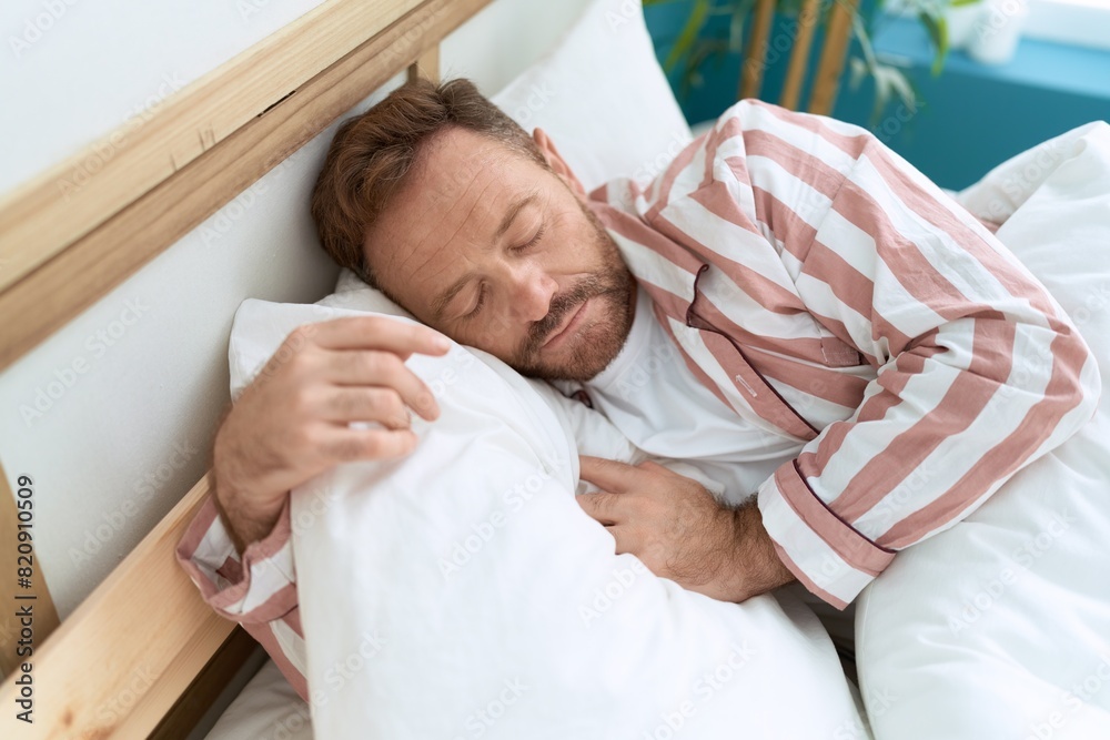 Middle age man lying on bed sleeping at bedroom Middle age man lying on bed sleeping at bedroom