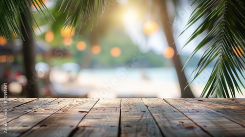 Fototapeta Naklejka Na Ścianę i Meble -  Empty wooden table top for product display, presentation stage. Tropical summer, palm trees, beach bar, white sand and blue ocean in the background.	
