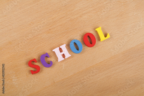 Foto SCHOOL word on wooden background composed from colorful abc alphabet block wooden letters, copy space for ad text