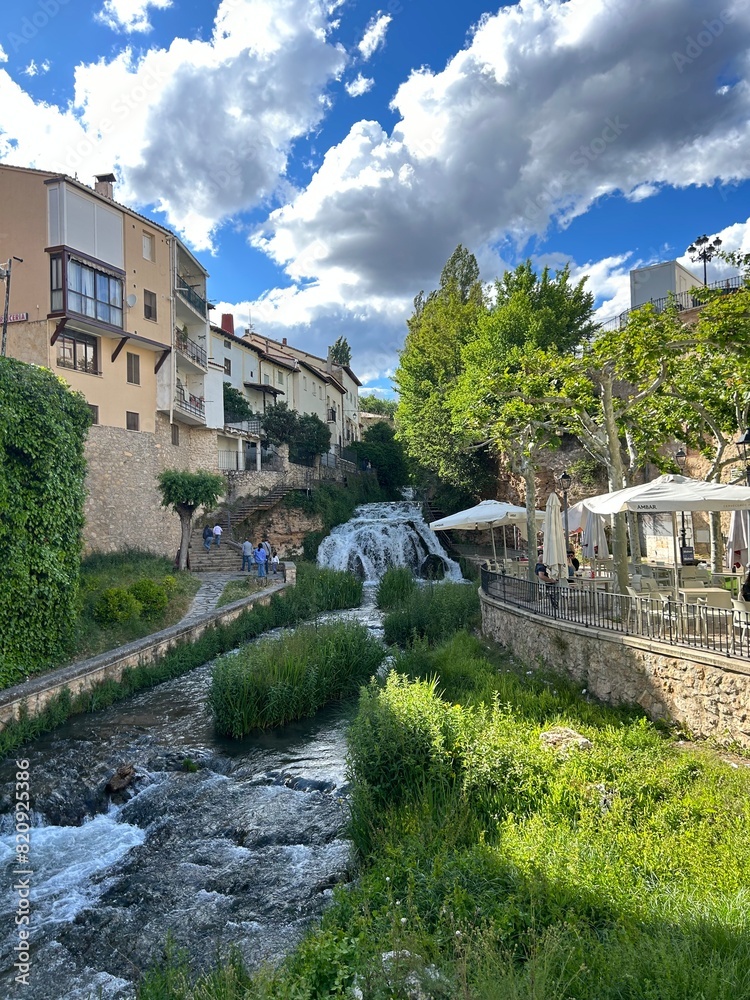 Obraz premium Waterfall in the middle of the town of Trillo in Guadalajara, Castilla la Mancha, Spain.