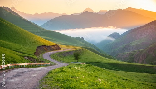 road in the green hills at foggy sunrise gil su valley in north caucasus russia