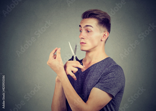 Liar man about to cut with scissors his imaginary long nose