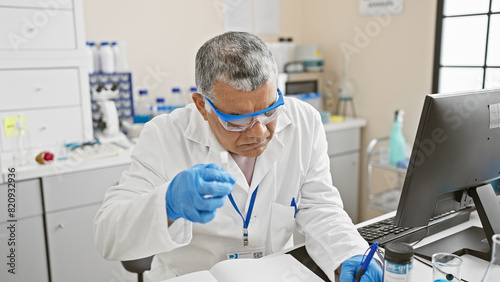 A mature man in a lab coat conducts research in a medical laboratory, meticulously analyzing samples.