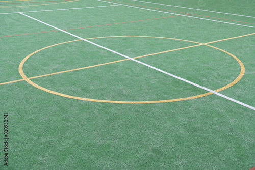 Artificial green grass carpet cover on a mini soccer playground. Artificial grass for sports surfaces.