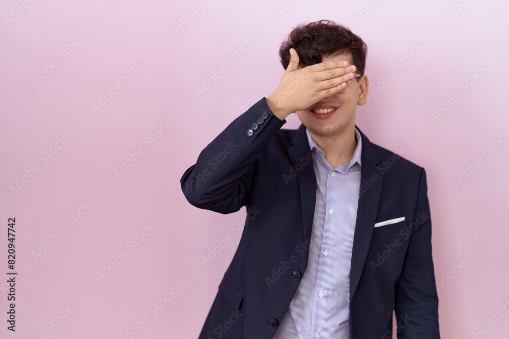 Young non binary man with beard wearing suit and tie smiling and laughing with hand on face covering eyes for surprise. blind concept. Young non binary man with beard wearing suit and tie smiling and laughing with hand on face covering eyes for surprise. blind concept.