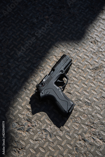 Modern semi-automatic pistol. Armament for the army and police. Short-barreled weapon. Gray concrete background.