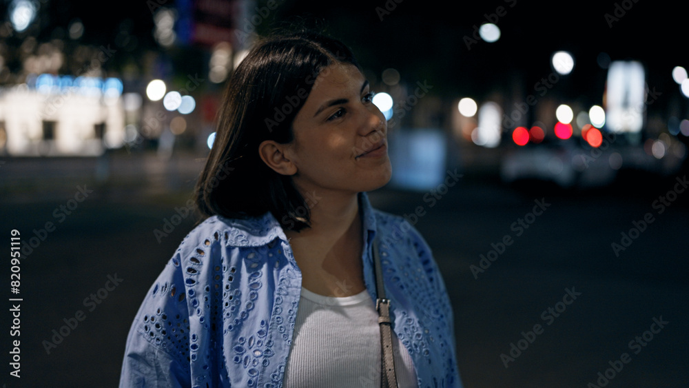 Young beautiful hispanic woman looking around in the streets at night Young beautiful hispanic woman looking around in the streets at night