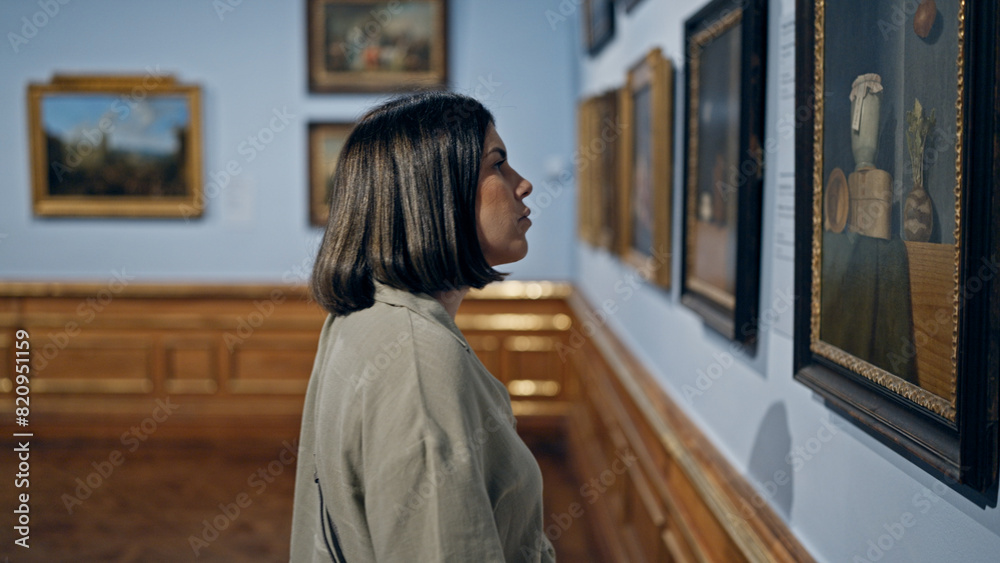 Young beautiful hispanic woman visiting art gallery at Belvedere Palace in Vienna