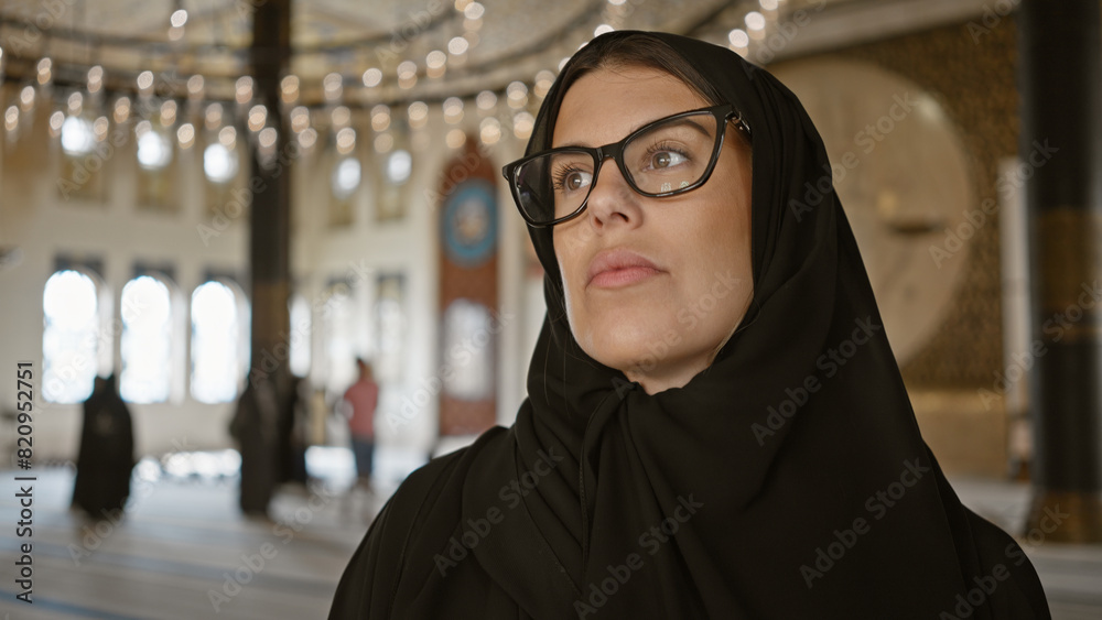 Thoughtful woman in hijab contemplating in ornate qatari mosque, embodying cultural tourism and islamic architecture Thoughtful woman in hijab contemplating in ornate qatari mosque, embodying cultural tourism and islamic architecture