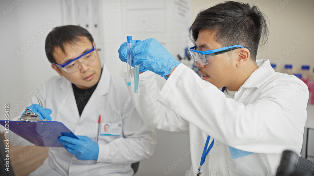 Two men in lab coats analyze samples in a science laboratory, embodying teamwork and research. Two men in lab coats analyze samples in a science laboratory, embodying teamwork and research.