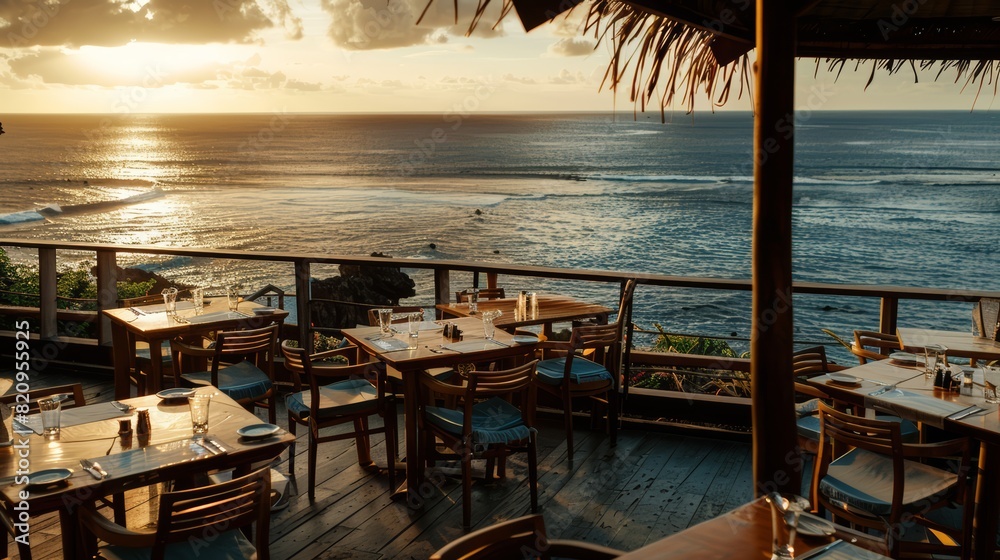 Fototapeta premium A restaurant overlooking the ocean at sunset