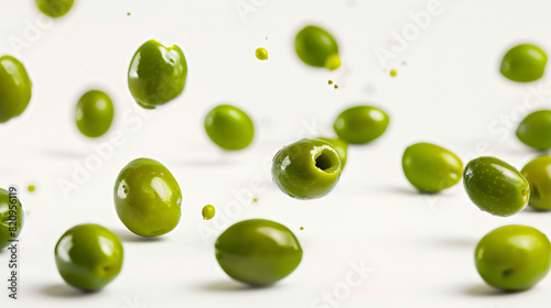 Falling green olives on white background