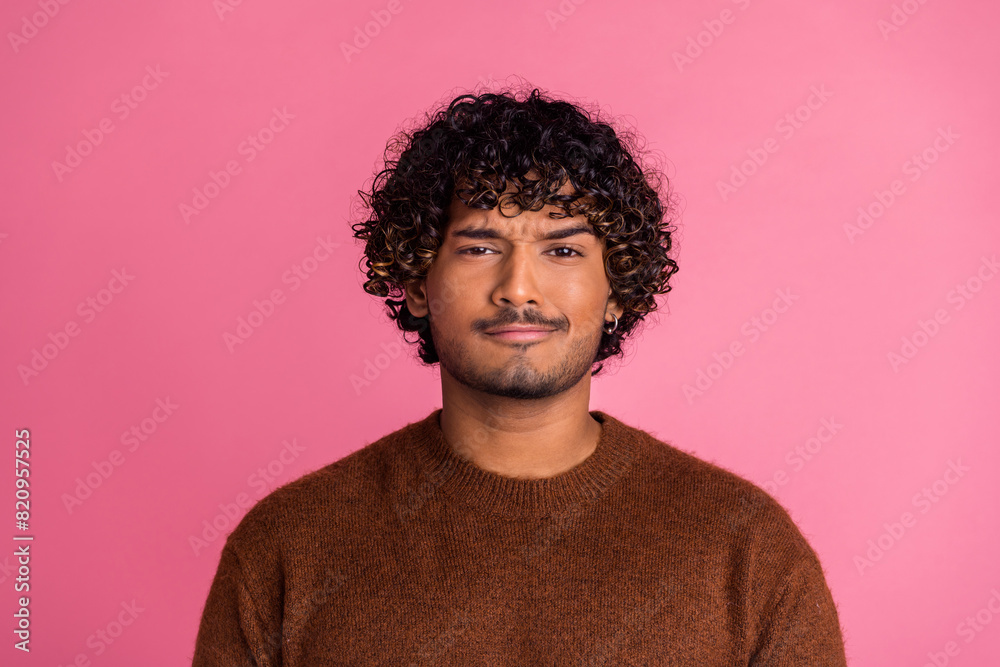 Photo of minded funny uncertain unsure man wear trendy brown clothes hmm isolated on pink color background Photo of minded funny uncertain unsure man wear trendy brown clothes hmm isolated on pink color background