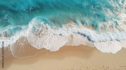 Aerial photo of ocean waves lapping onto a tropical beach 16:9 ratio 