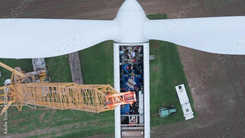 Green wind energy from renewable sources and zero carbon footprint. Wind turbine repaired by workers, maintenance of turbine