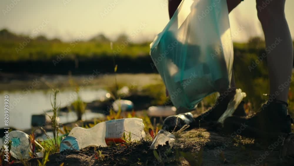 A man sorts plastic bottles and other waste and places it in a garbage bag. By carefully collecting plastic waste, it promotes further recycling and sustainable disposal of disposable tableware