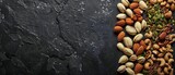 Snacking on raw nuts and seeds can boost energy and support a healthy food diet, with a solid background and copy space on center for advertise