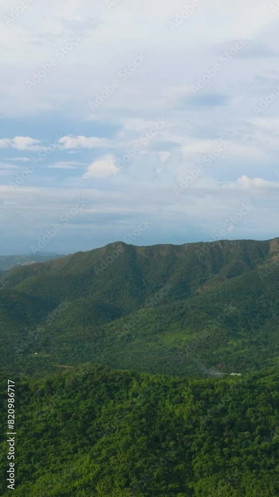 Mountain slopes covered with rainforest and jungle. View of the valley in the mountain province. Coron, Palawan. Philippines. Vertical view. Mountain slopes covered with rainforest and jungle. View of the valley in the mountain province. Coron, Palawan. Philippines. Vertical view.