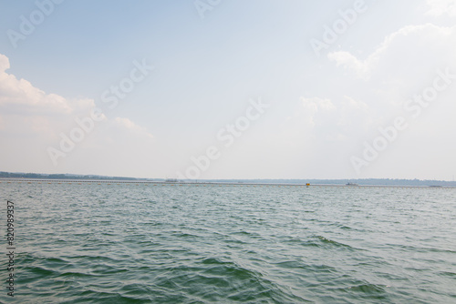 Seascape with floating buoys and rope separation area on the beach. A safety zone towing buoy floats above the sea. photo