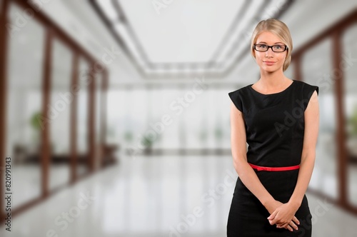 Business young happy woman posing in an office.