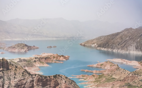 Panoramic view of the Nurek reservoir in the mountains of Tajikistan, landscape of a blue lake in the hot mountains