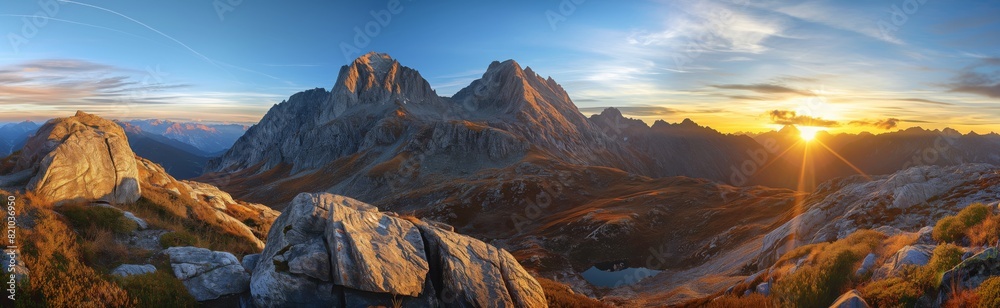 Majestic mountain peaks bathed in golden sunrise light, evoking a sense of adventure and the grandeur of nature