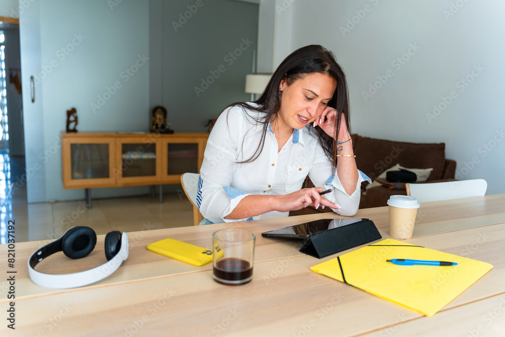 Middle aged Romanian businesswoman using a tablet to telework Middle aged Romanian businesswoman using a tablet to telework