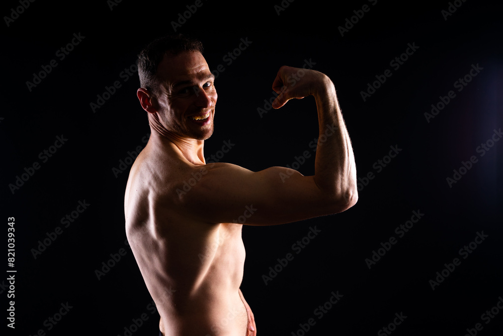 Fototapeta premium Portrait of man, bodybuilder and bicep flex in studio, background and exercise for muscular power.