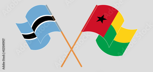 Crossed and waving flags of Botswana and Guinea-Bissau