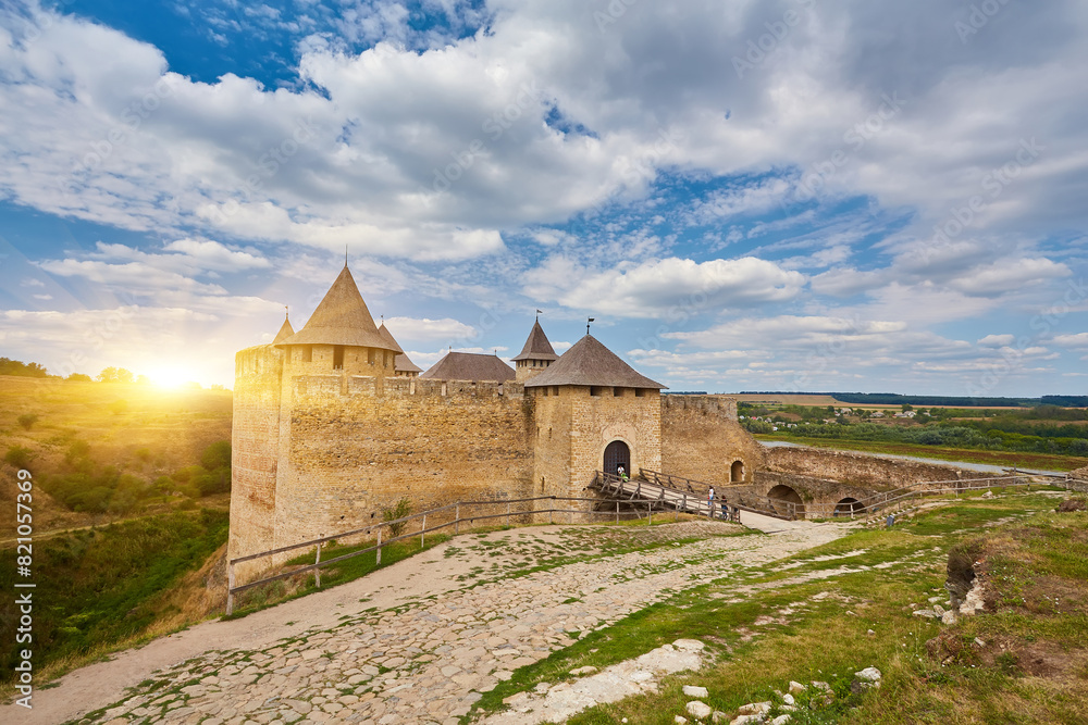 Ancient fortress in Khotyn in morning sun with mist, West Ukraine. Fortification on the banks of the Dniester River, one of the most famous and largest castles in Ukraine.