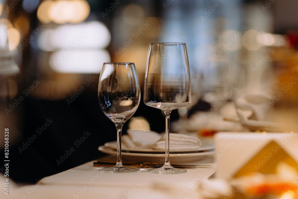 A close up shot of a restaurant table set up with tableware and wine glass. Concept of dining, hospitality and catering. A close up shot of a restaurant table set up with tableware and wine glass. Concept of dining, hospitality and catering.