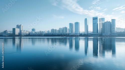 A city skyline of futuristic buildings along the river. © imlane