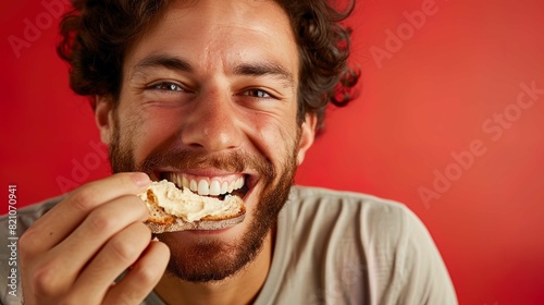 A close frontal view of a Swiss man savoring a bite of bread with creamy hummus  with emphasis on his joyous expression. The texture of the hummus on the bread is meticulously highlighted