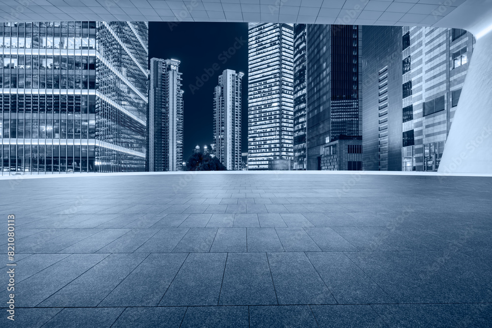 Fototapeta Empty square floors with modern buildings at night in shanghai