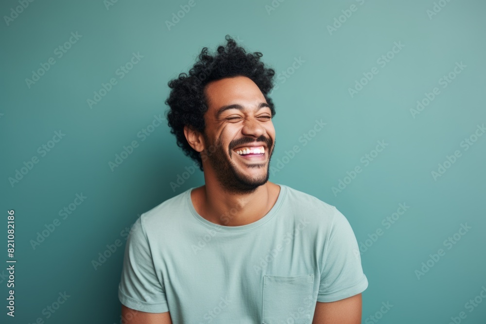 Portrait of a smiling man in his 30s laughing isolated on solid color backdrop Portrait of a smiling man in his 30s laughing isolated on solid color backdrop