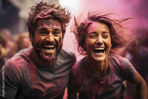 Excited couple laughing during Holi party © TENphoto