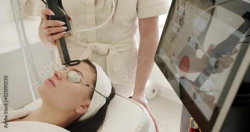 Facial rejuvenation, beauty woman with protective glasses, aesthetic medicine is performing procedure. Woman getting LPG hardware massage at the beauty clinic. Beauty treatment. photo