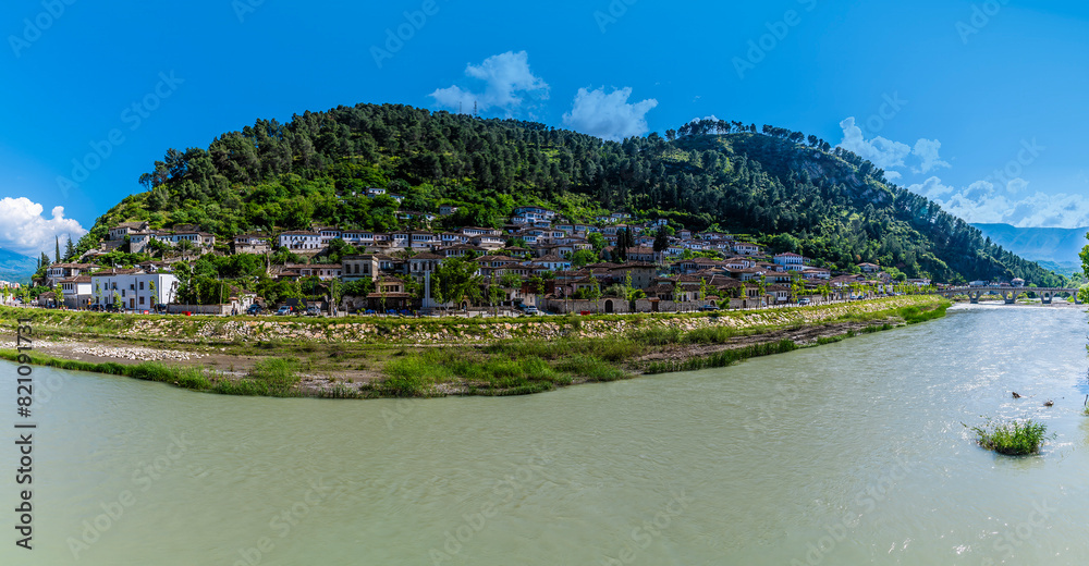 A panorama view across the River Osum on a bend down the south bank of the Old Quarter in Berat, Albania in summertime